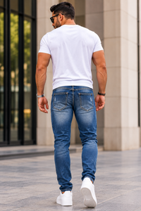 Men wearing distressed blue stretch jeans back view